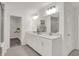 Bathroom featuring double vanity, large mirror, modern lights, tile flooring, and walk-in closet at 19452 Lewis Cir, Westfield, IN 46074
