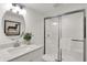 Bathroom features a glass-enclosed shower, modern sink, and stylish round mirror at 19452 Lewis Cir, Westfield, IN 46074