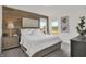 Comfortable bedroom with wood accent wall, bright windows and neutral decor at 19452 Lewis Cir, Westfield, IN 46074