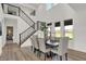 Bright dining area with modern furnishings, tall ceiling and large windows allowing for natural light at 19452 Lewis Cir, Westfield, IN 46074