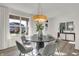 Bright dining room featuring modern chandelier over a dark table with seating for six at 19452 Lewis Cir, Westfield, IN 46074