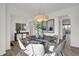 Bright dining room featuring modern chandelier over a dark table with seating for six at 19452 Lewis Cir, Westfield, IN 46074
