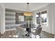 Elegant dining room featuring modern light fixture and decor with a large window and natural light at 19452 Lewis Cir, Westfield, IN 46074