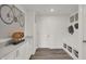 Bright mudroom features built in storage, bench, modern wood look floors and white walls at 19452 Lewis Cir, Westfield, IN 46074