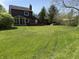 Large backyard featuring a deck and sunroom, ideal for outdoor living and recreation at 30 Village Ct, Zionsville, IN 46077