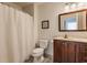 Simple bathroom with a brown vanity, toilet, and shower at 30 Village Ct, Zionsville, IN 46077