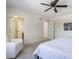 Spacious bedroom with a queen bed, ceiling fan, and access to bathroom at 30 Village Ct, Zionsville, IN 46077