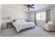 Bright bedroom with a queen-size bed, window, and ceiling fan at 30 Village Ct, Zionsville, IN 46077