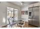 Kitchen breakfast nook with glass table and chairs, adjacent to sunroom at 30 Village Ct, Zionsville, IN 46077