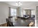 Elegant dining room with dark wood table and six chairs, open to living area at 30 Village Ct, Zionsville, IN 46077