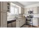 Kitchen with light beige cabinets, stainless steel appliances, and granite countertops at 30 Village Ct, Zionsville, IN 46077