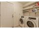 Laundry room with washer, dryer, and shelving for storage at 30 Village Ct, Zionsville, IN 46077