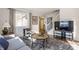 Bright living room with gray sofa, wood coffee table and hardwood floors at 30 Village Ct, Zionsville, IN 46077