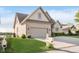 View of a home's brick exterior, attached two car garage, landscaped lawn, and neighborhood setting at 3150 Beach Blvd, Cicero, IN 46034