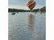 Hot air balloon over calm lake water with boats at 3150 Beach Blvd, Cicero, IN 46034