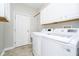 Bright laundry room, featuring washer, dryer, and cabinets at 3150 Beach Blvd, Cicero, IN 46034