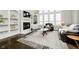 Bright living room boasts hardwood floors, a fireplace, and custom built-in shelving at 3150 Beach Blvd, Cicero, IN 46034