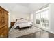 Spacious main bedroom with hardwood floors and access to a deck at 3150 Beach Blvd, Cicero, IN 46034