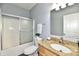 Bathroom with granite countertop vanity, white tub, and tiled shower at 316 Society Dr, Indianapolis, IN 46229