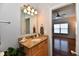 Bathroom vanity area with granite counters and a mirror, opens to a bedroom space at 316 Society Dr, Indianapolis, IN 46229