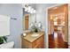 Bathroom featuring vanity with granite countertop, large mirror, and updated fixtures at 316 Society Dr, Indianapolis, IN 46229