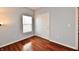 This bedroom has wood floors, a window with blinds, and a closet with sliding doors at 316 Society Dr, Indianapolis, IN 46229