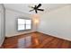 Bright bedroom featuring hardwood floors, a ceiling fan, and a large window for natural light at 316 Society Dr, Indianapolis, IN 46229