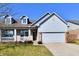 A welcoming single-Gathering home featuring a front porch, dormer windows, and attached garage at 316 Society Dr, Indianapolis, IN 46229