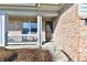 Inviting brick-clad front porch and entry featuring a storm door and space to relax at 316 Society Dr, Indianapolis, IN 46229