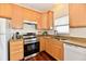 This eat-in kitchen features wood cabinets, stainless steel appliances, and granite countertops at 316 Society Dr, Indianapolis, IN 46229