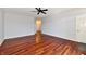 An empty living room featuring shiny hardwood floors, gray paint, and a ceiling fan at 316 Society Dr, Indianapolis, IN 46229