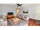 A staged living room featuring hardwood floors, gray paint, and stylish furniture at 316 Society Dr, Indianapolis, IN 46229
