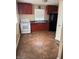 Kitchen with wood cabinets, white appliances, and tile floor at 3355 Wallace Ave, Indianapolis, IN 46218