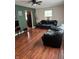 Living room with hardwood floors, neutral walls and black leather couches at 3355 Wallace Ave, Indianapolis, IN 46218