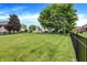 Spacious grassy backyard with a playset and a home in the background at 3828 Highland Park Dr, Greenwood, IN 46143