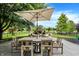 Patio furniture under an umbrella, with a fire pit in the background at 3828 Highland Park Dr, Greenwood, IN 46143