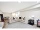 Finished basement with sectional sofa, ping pong table, and plenty of space for recreation at 3828 Highland Park Dr, Greenwood, IN 46143