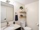 Modern bathroom with floating shelves, stylish vanity, and a sleek toilet at 3828 Highland Park Dr, Greenwood, IN 46143