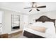 Bright bedroom featuring a king-size bed and large mirror at 3828 Highland Park Dr, Greenwood, IN 46143
