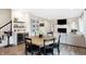 Round wooden dining table with black chairs and wine bar at 3828 Highland Park Dr, Greenwood, IN 46143
