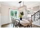 Charming dining room with a large window and wood table at 3828 Highland Park Dr, Greenwood, IN 46143