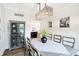 Bright dining room featuring a rustic table and modern chandelier at 3828 Highland Park Dr, Greenwood, IN 46143