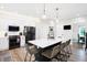 Modern kitchen with white cabinets, black appliances, and a large island at 3828 Highland Park Dr, Greenwood, IN 46143