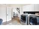 Bright laundry room with washer, dryer, and ample counter space at 3828 Highland Park Dr, Greenwood, IN 46143