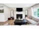 Living room features a fireplace, sectional sofa and large windows at 3828 Highland Park Dr, Greenwood, IN 46143