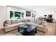 Spacious living room featuring a large sectional sofa, coffee table, and views to backyard at 3828 Highland Park Dr, Greenwood, IN 46143