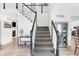 Modern staircase with black railings and gray carpeting at 3828 Highland Park Dr, Greenwood, IN 46143