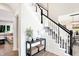 Elegant staircase with black and white railings and a console table at 3828 Highland Park Dr, Greenwood, IN 46143