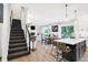 Modern staircase with dark carpeting and metal railing, open to kitchen and living areas at 3828 Highland Park Dr, Greenwood, IN 46143