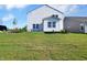 Spacious backyard featuring a well-manicured lawn and a modern white home exterior with large windows at 5107 Maddox Ln, Whitestown, IN 46075